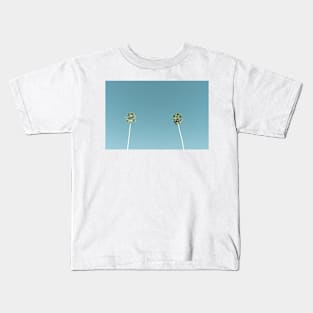 Tall fan palm trees against blue sky Kids T-Shirt